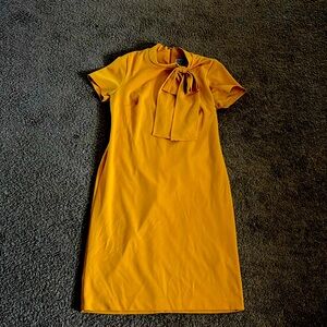 This is a mustard mid neck dress that was originally purchased from K&G